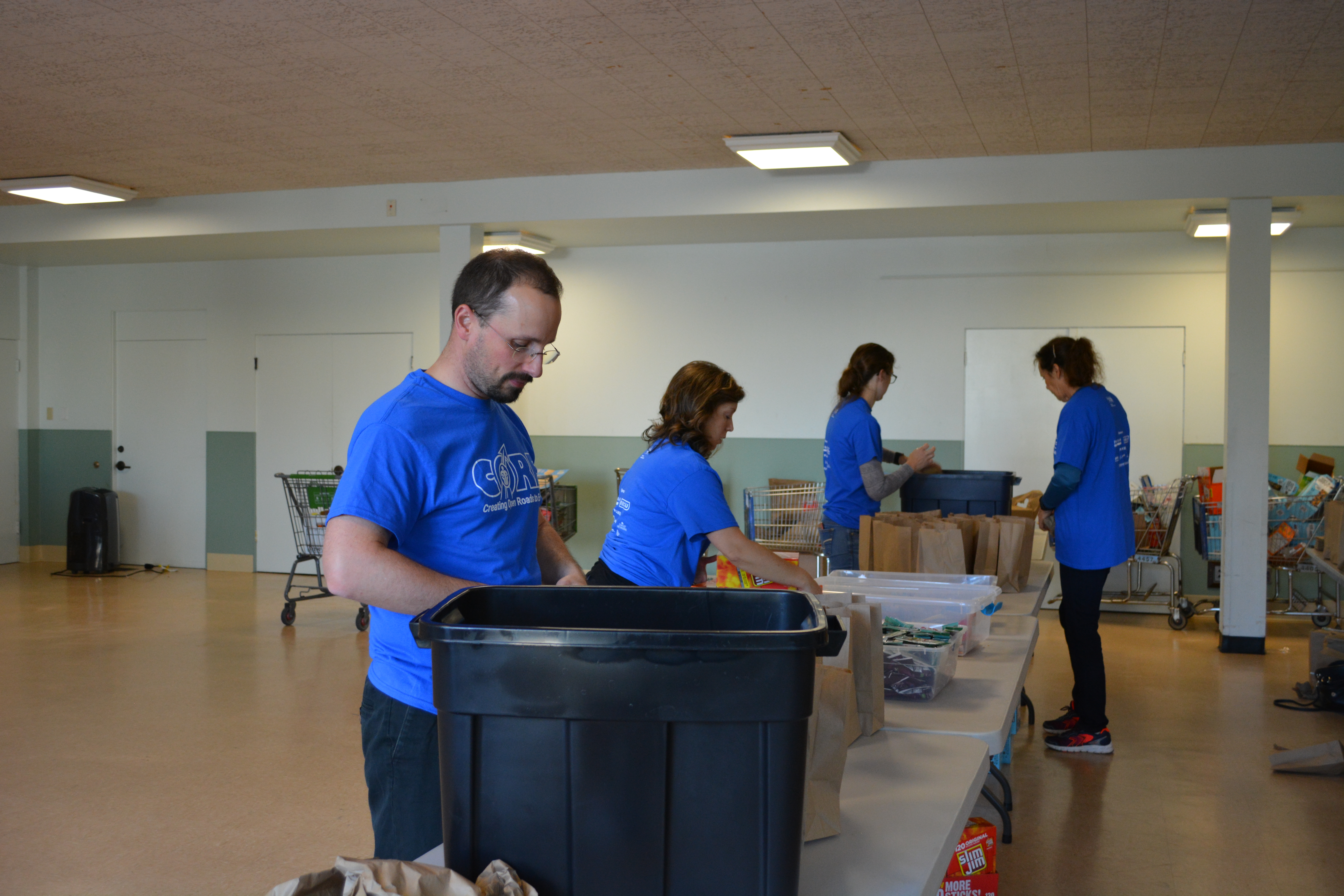 Volunteers packing snack kits for Washington Kids in Transition