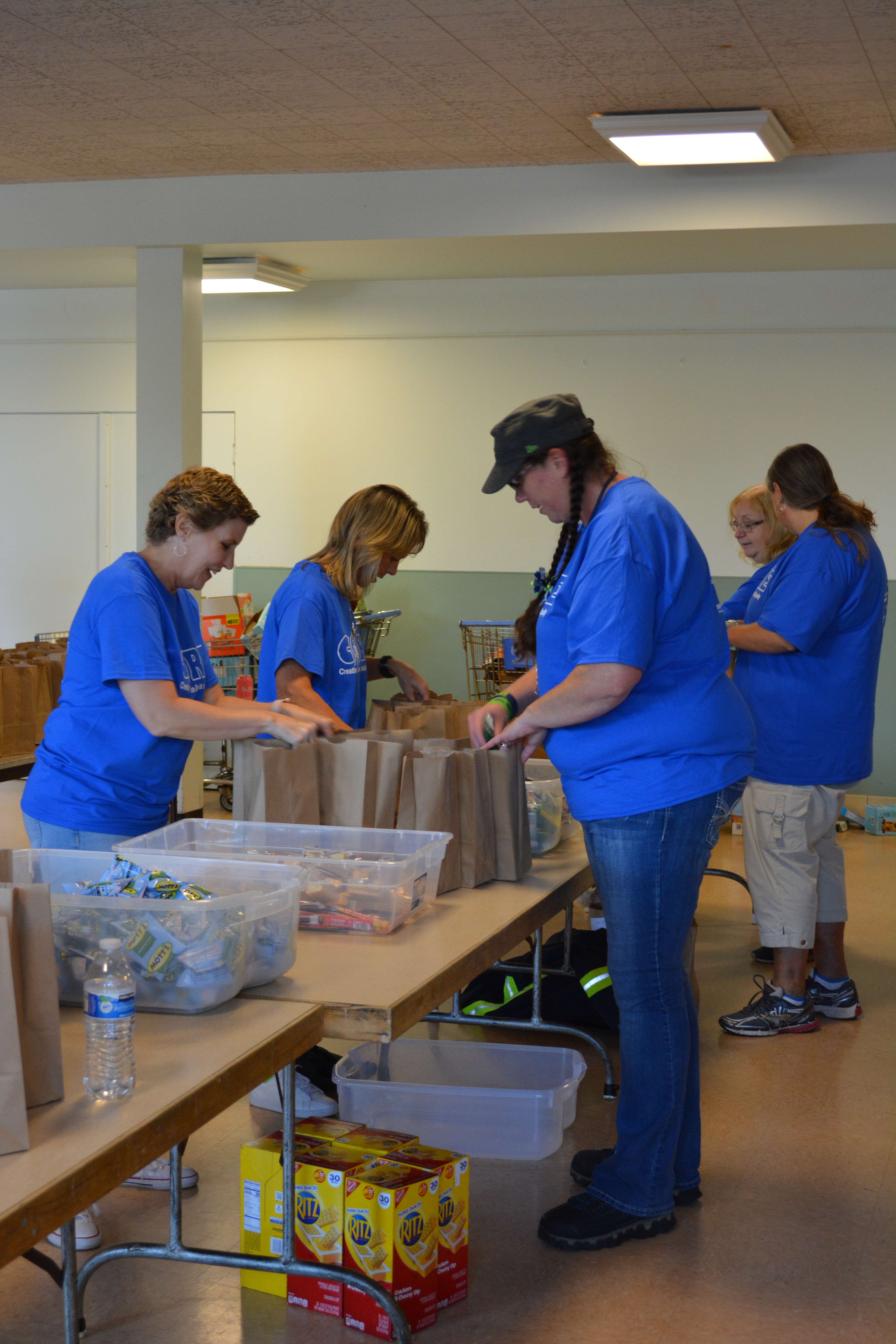 Volunteers packing snack kits for Washington Kids in Transition