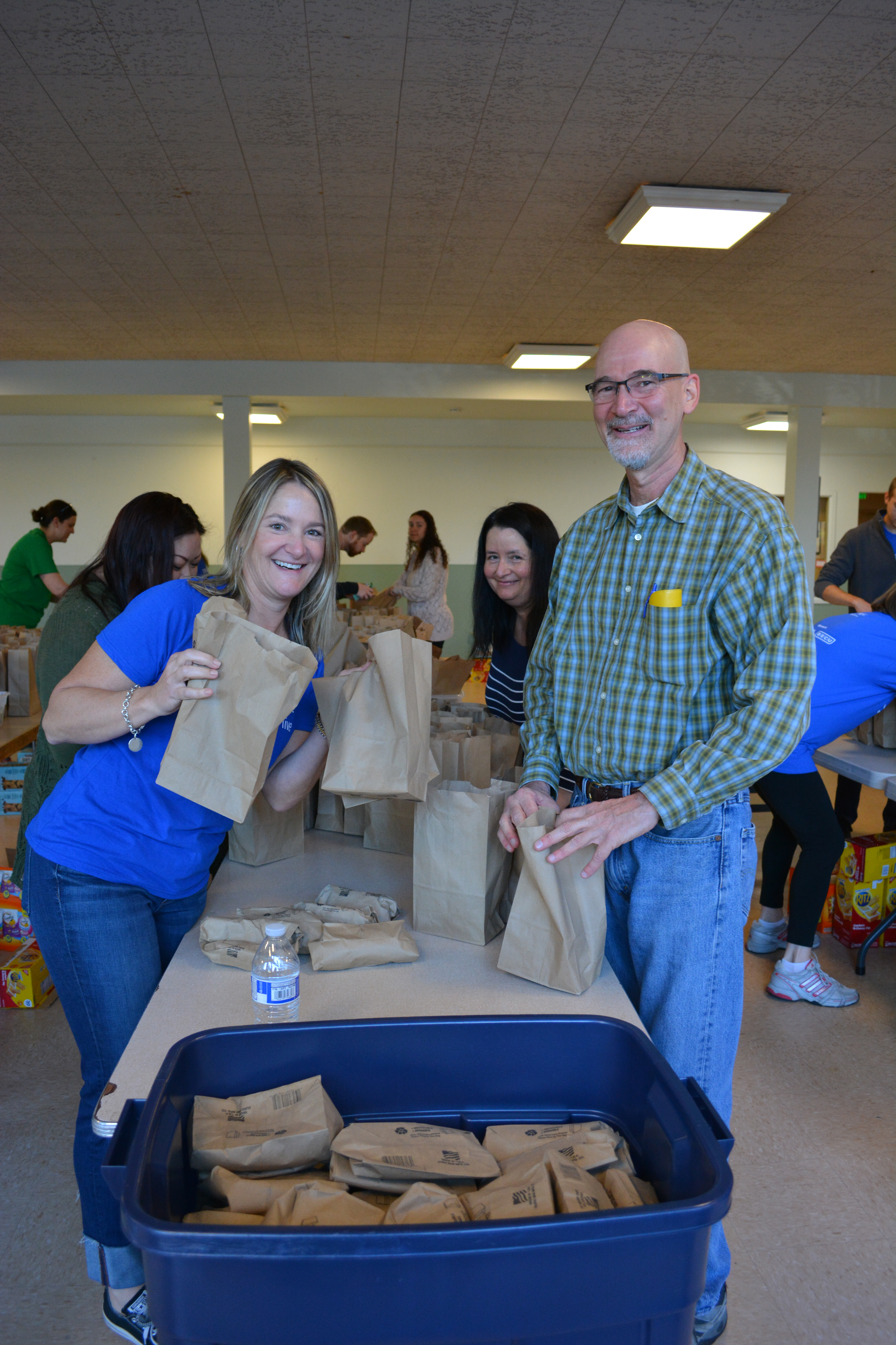 Volunteers packing snack kits for Washington Kids in Transition