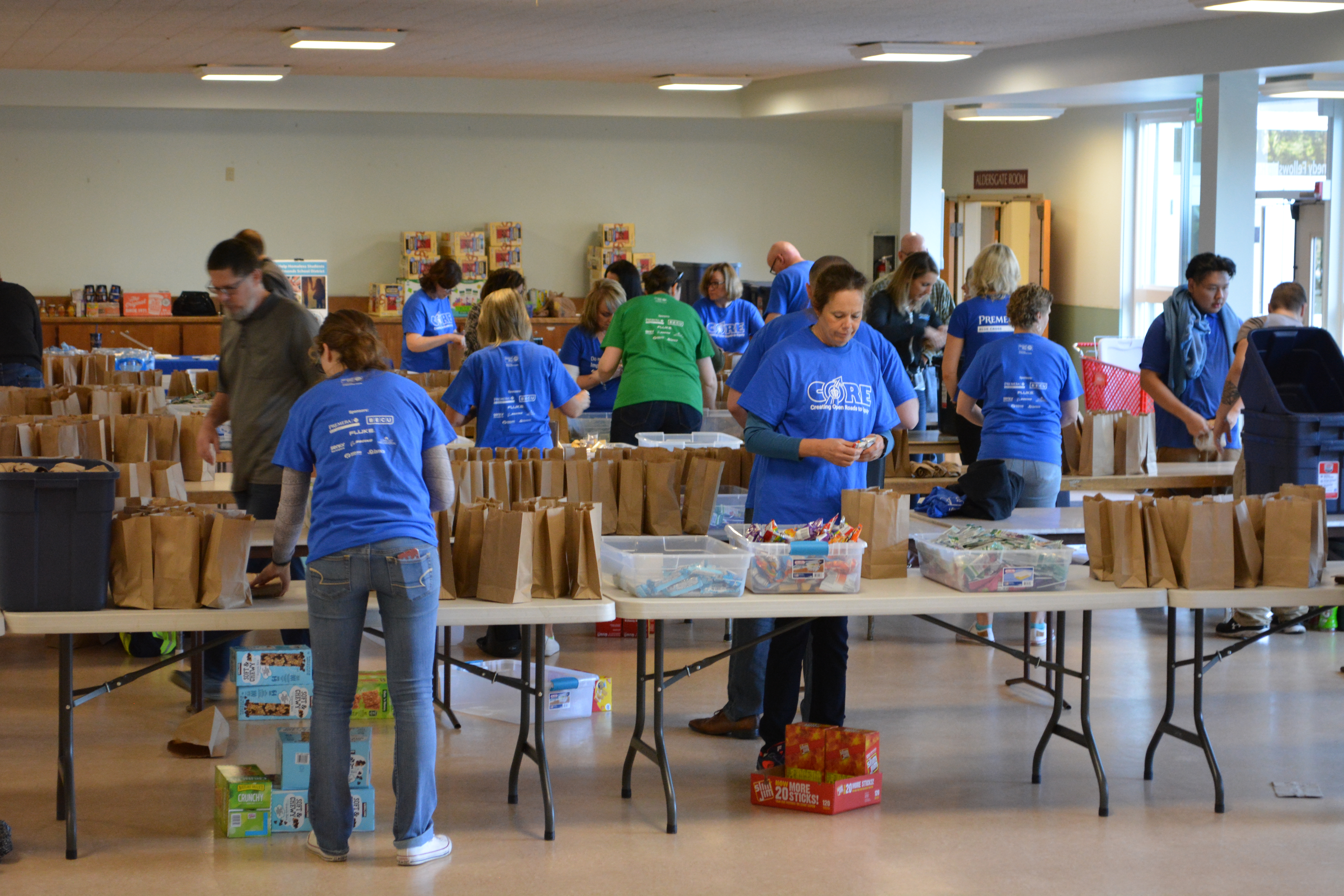 Volunteers packing snack kits for Washington Kids in Transition