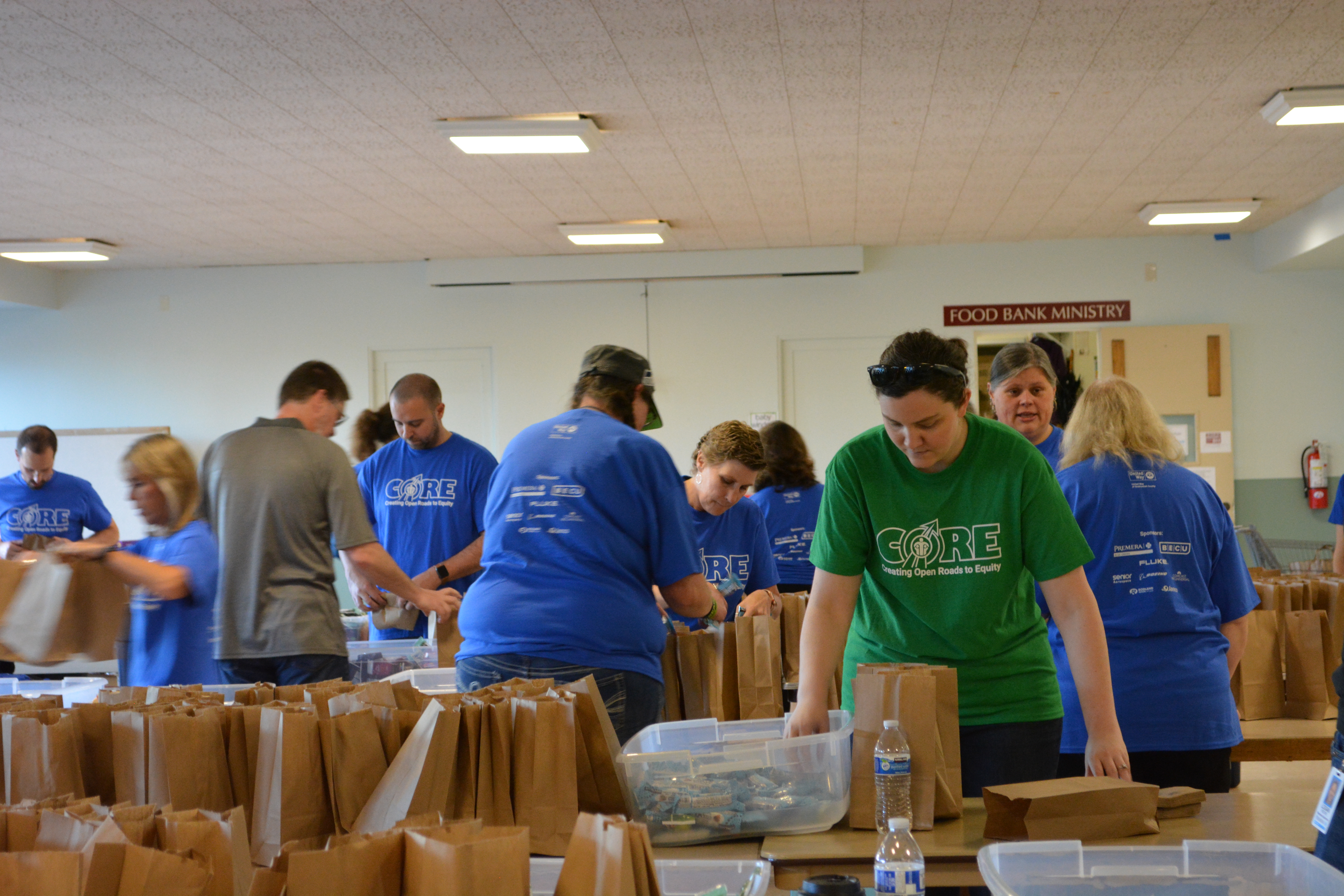 Volunteers packing snack kits for Washington Kids in Transition